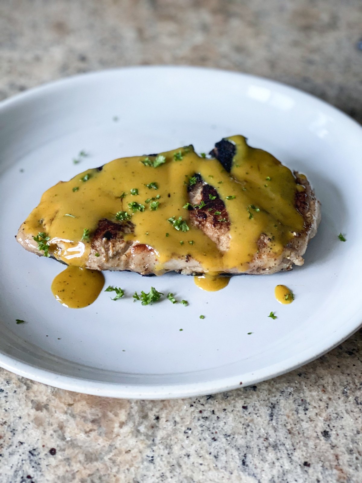 sous vide pork chops recipe with yellow bbq sauce and herbs