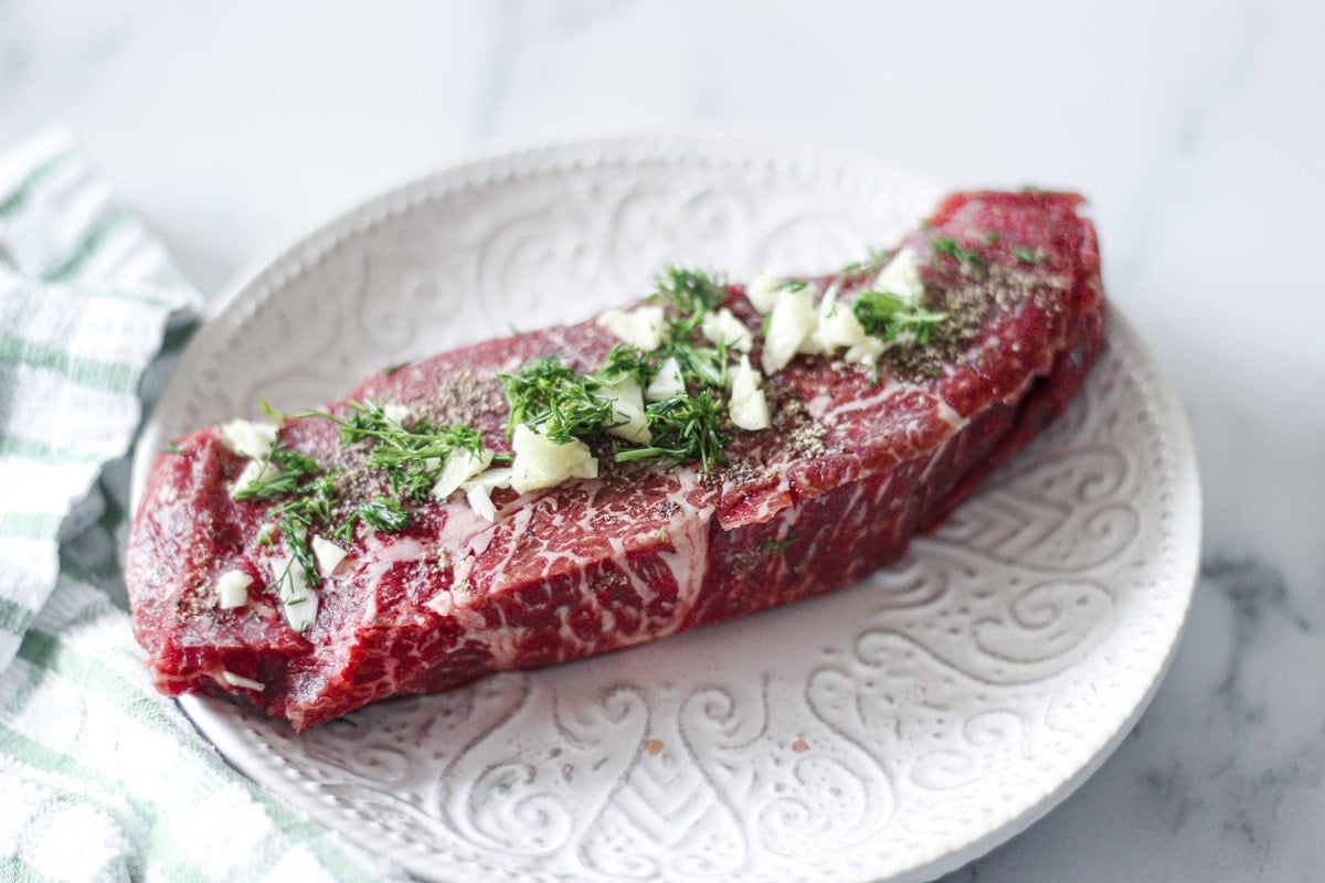 raw sous vide denver steak with dill and garlic