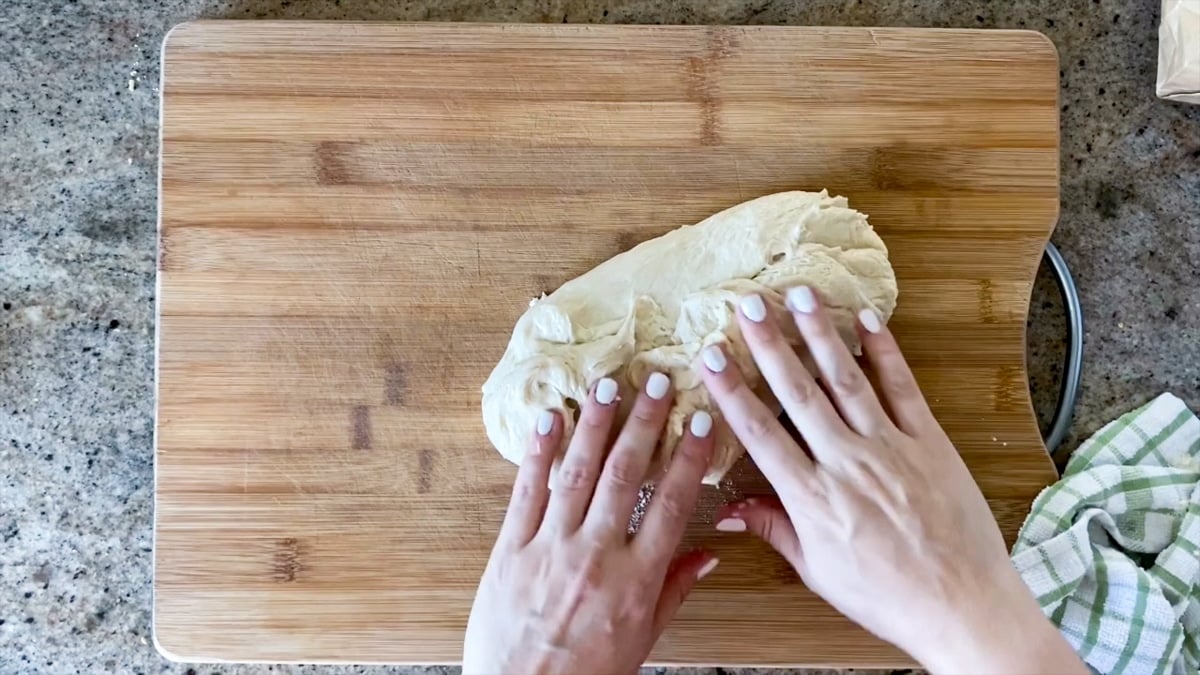 starting to stretch pizza dough by hand