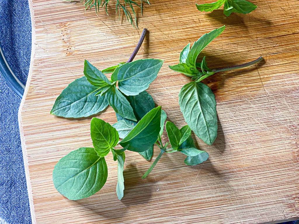 fresh cut aerogarden herbs on a cutting board