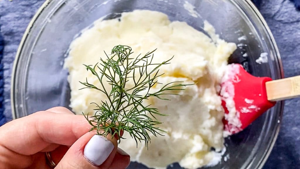 adding fresh dill to mashed potatoes