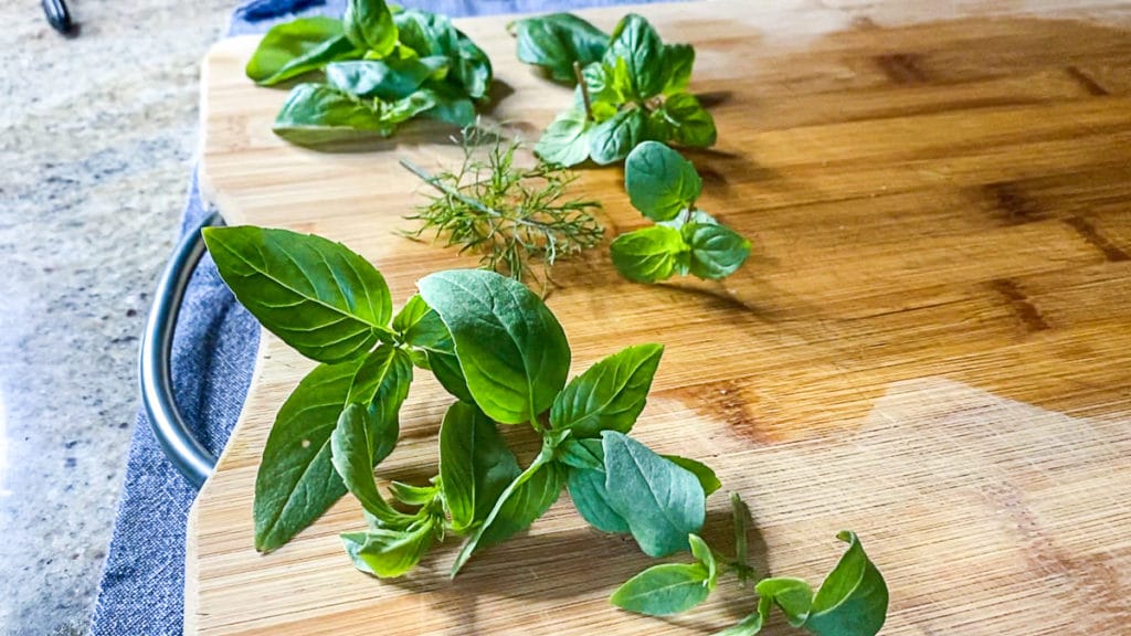 fresh herbs for cooking on cutting board