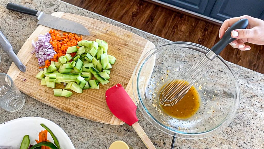 making a cucumber veggie salad with fresh herbs