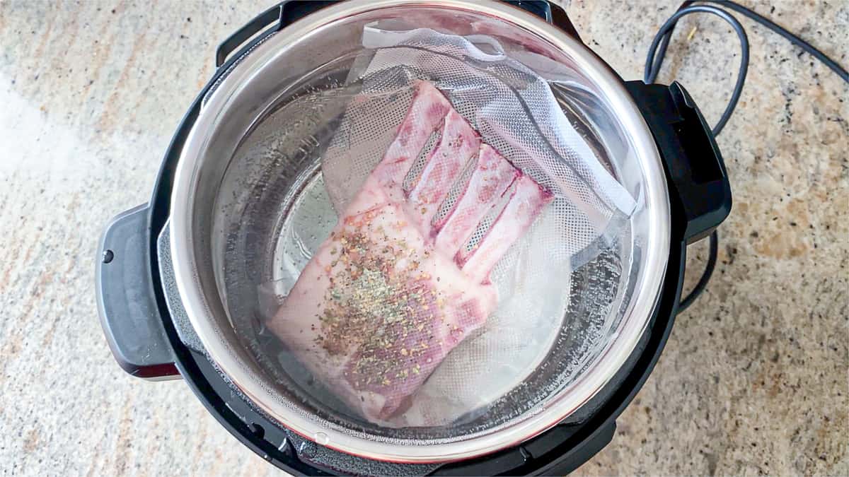 top shot of meat in vacuum sealed bag in water bath