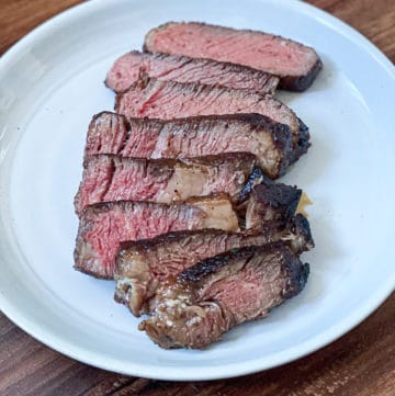 sliced medium rare sous vide boneless ribeye steak on a plate