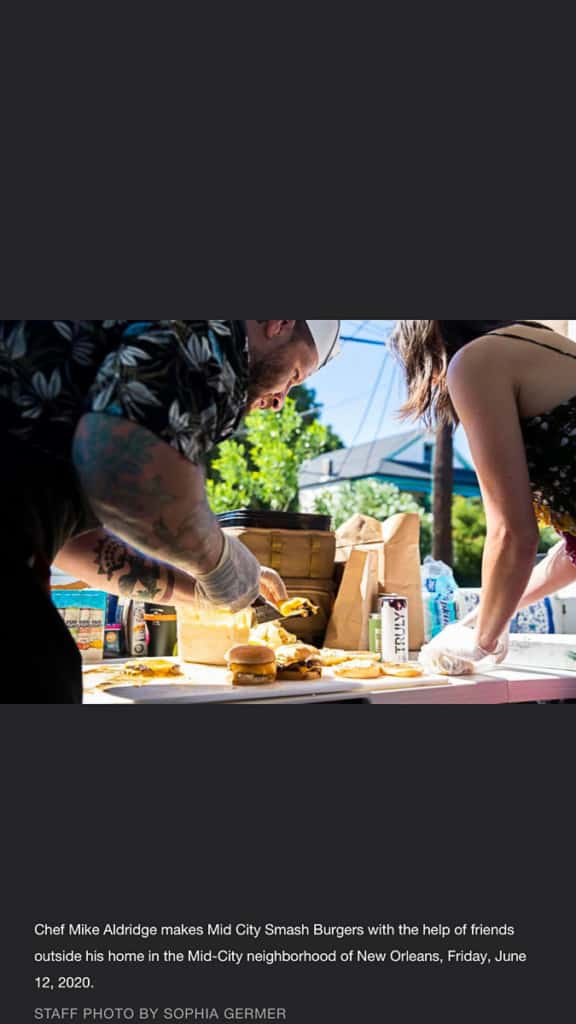 man and woman assembling burgers