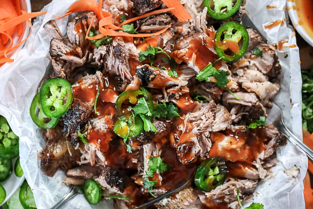 Top shot of barbecue pork shredded with jalapenos and barbecue sauce.