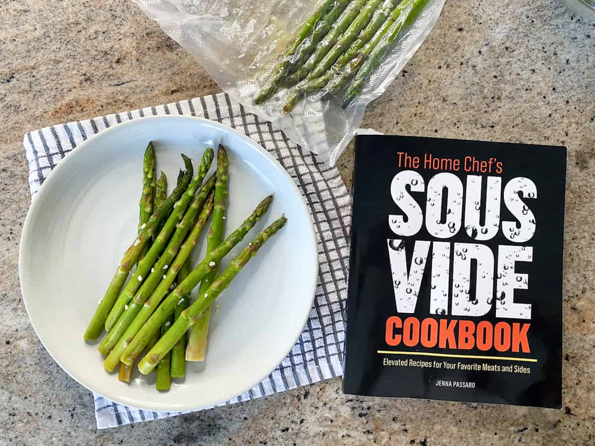 Top down shot of Instant Pot sous vide asparagus and the home chef's sous vide cookbook.