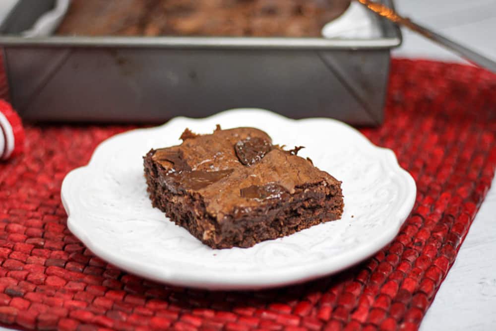 Side shot of chocolate chip brownie on a plate.