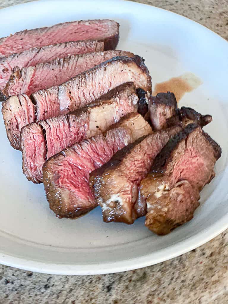 Top shot of ribeye steak dinner on a plate.