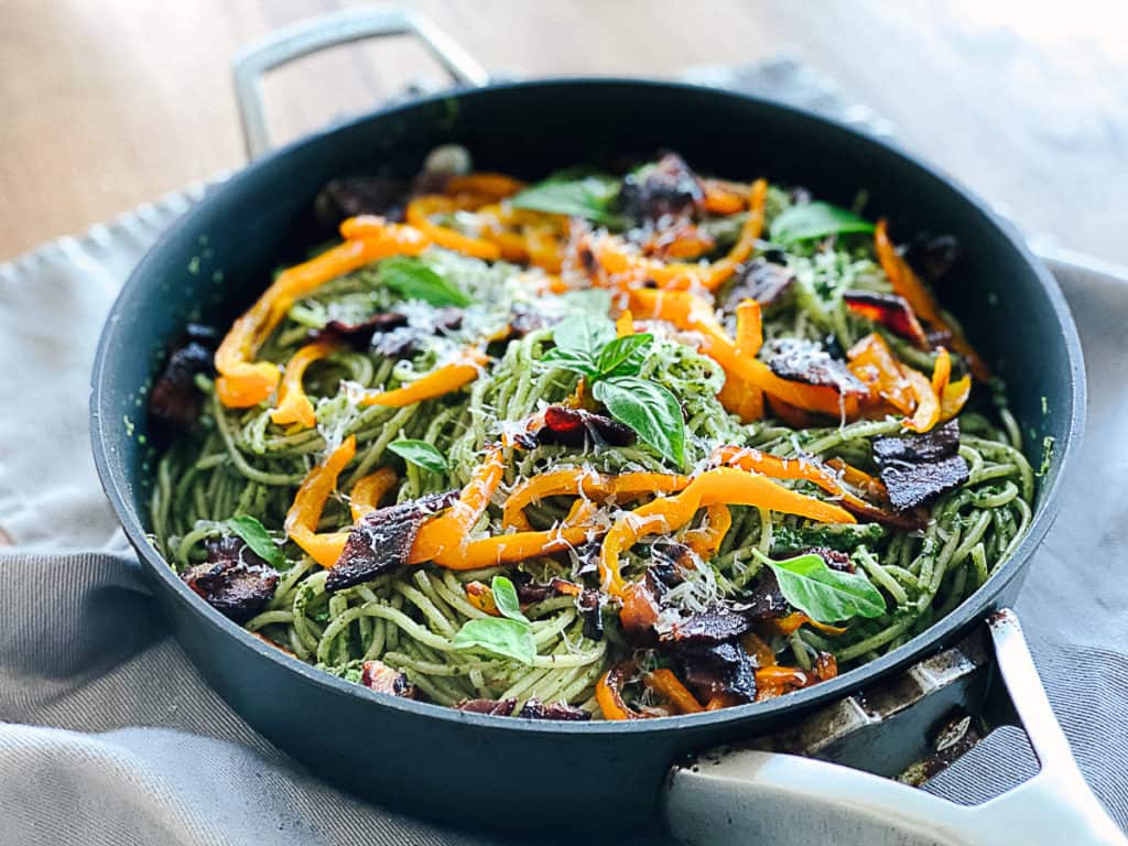 Side shot of spinach pasta dish.