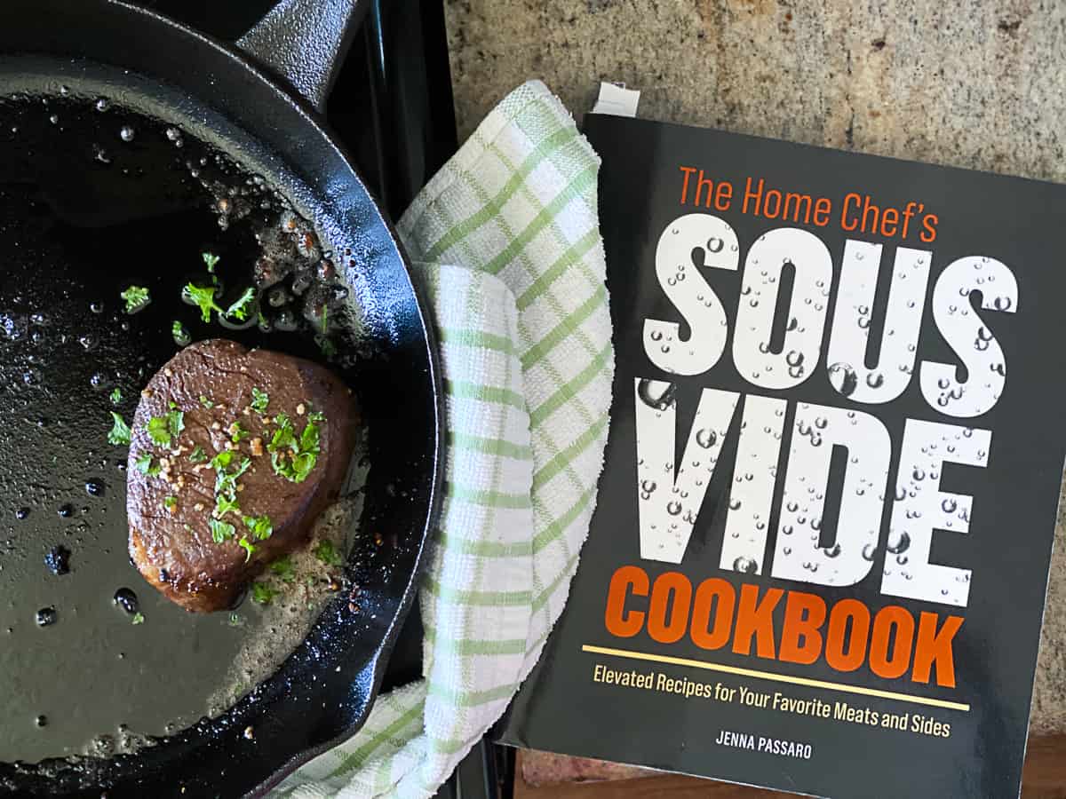 The Home Chef's Sous Vide cookbook next to a pan with fillet mignon steak.