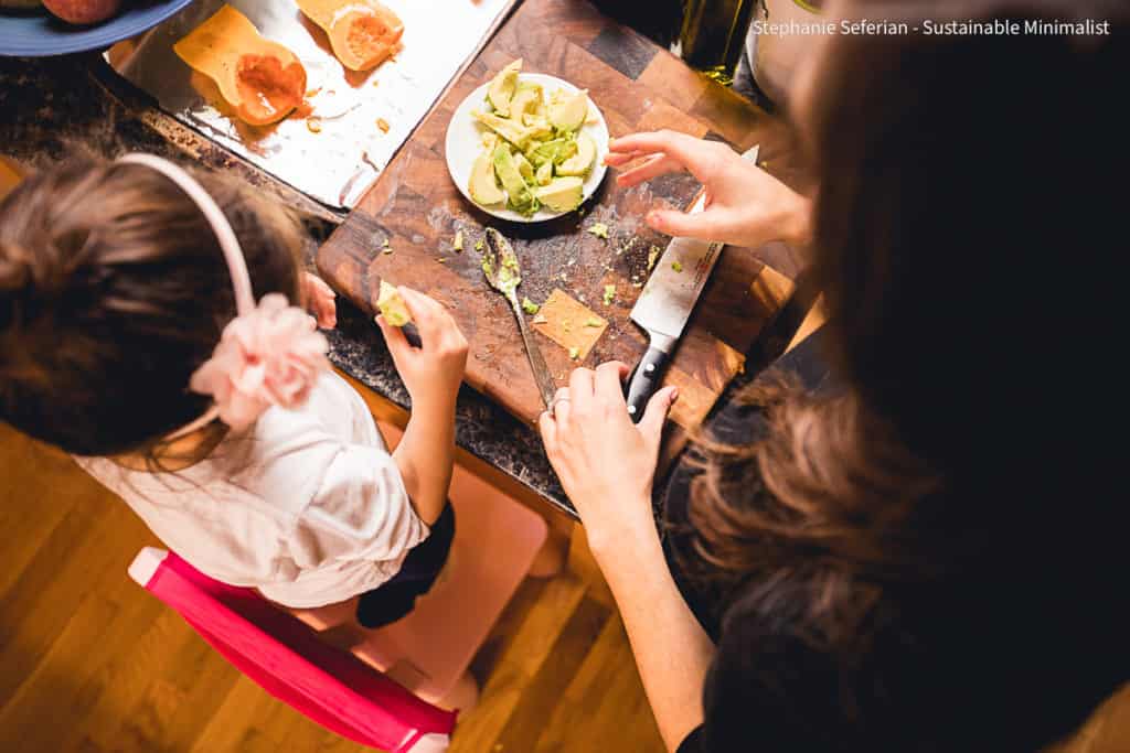 Top down shot of child and woman cooking together.