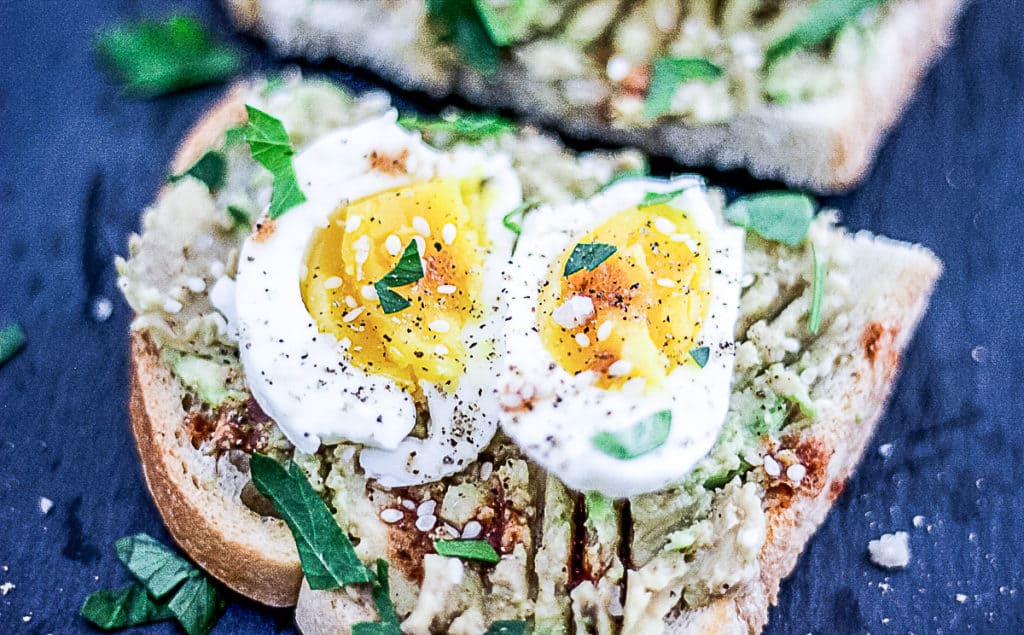 Closeup of sous vide soft boiled egg on avocado toast.