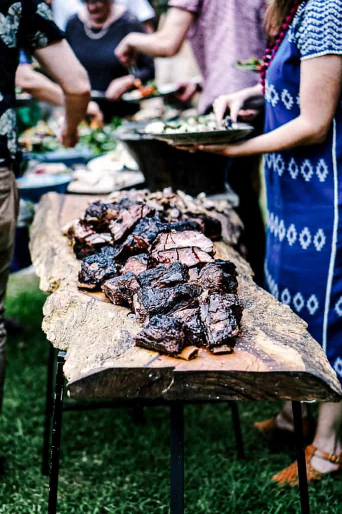 Side shot of smoked meats on a table at a bbq party.