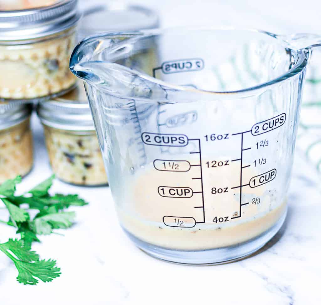 Side shot of measuring cup with scrambled eggs for sous vide cooking.