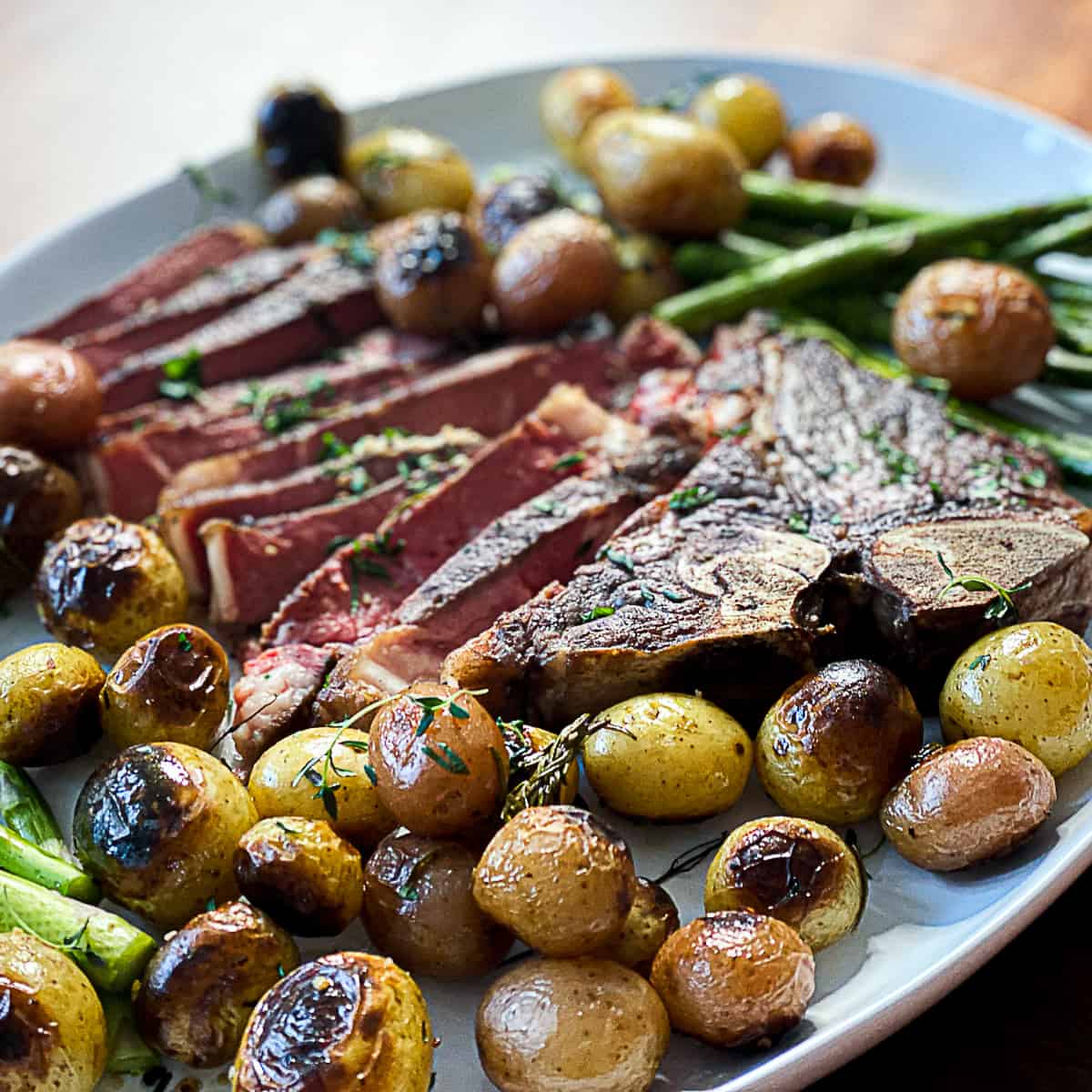 Side shot of sous vide steak dinner with herb seasoning and potatoes.