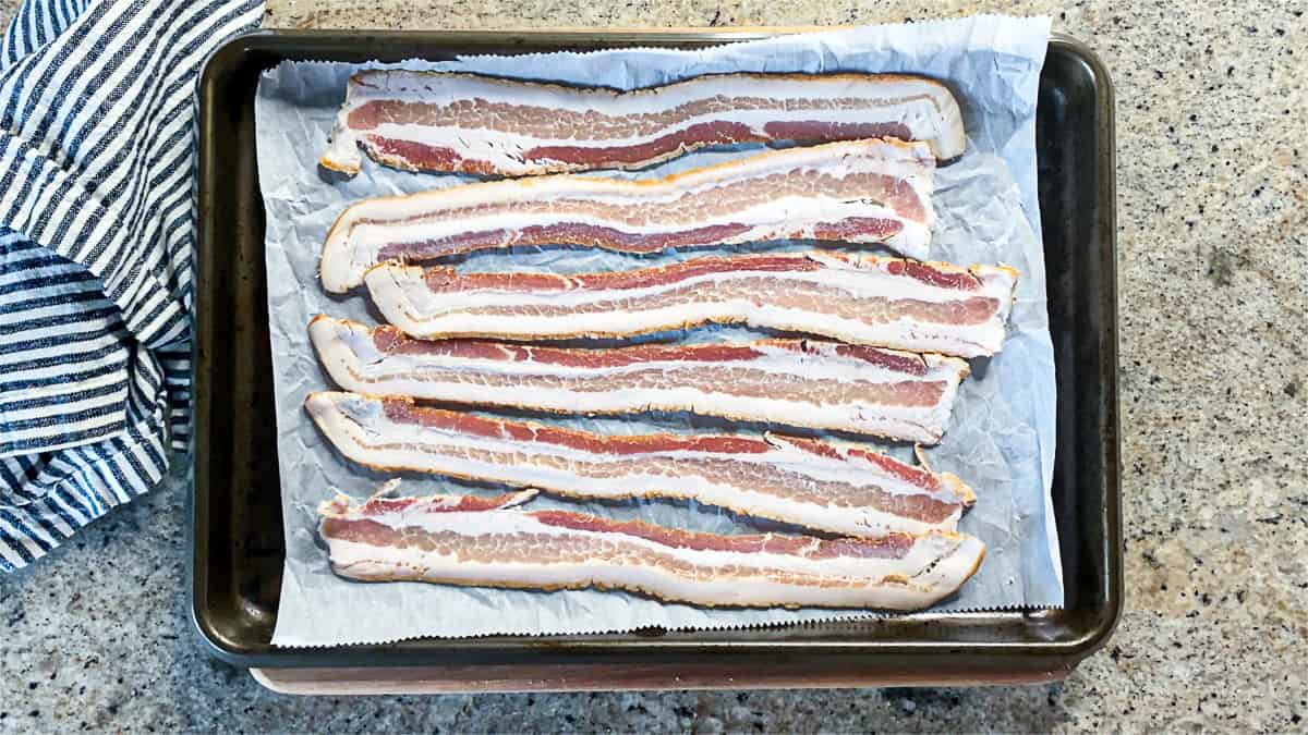 Top down shot of bacon on a sheet tray.