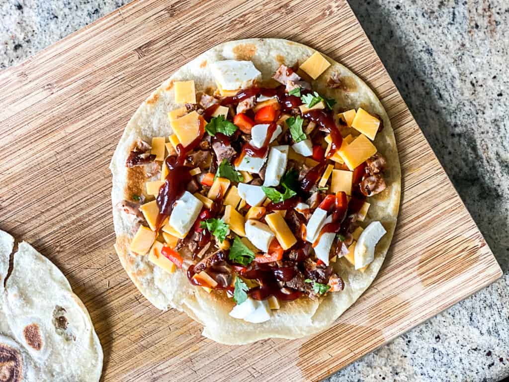 Top down shot demonstrating using a frozen then thawed flour tortilla to make a quesadilla.