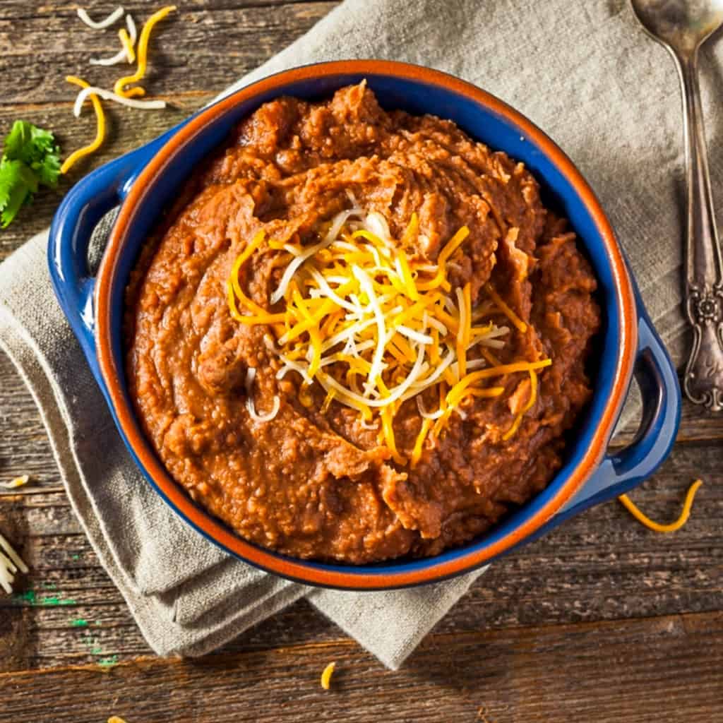 Top down shot of refried bean dip for a party.