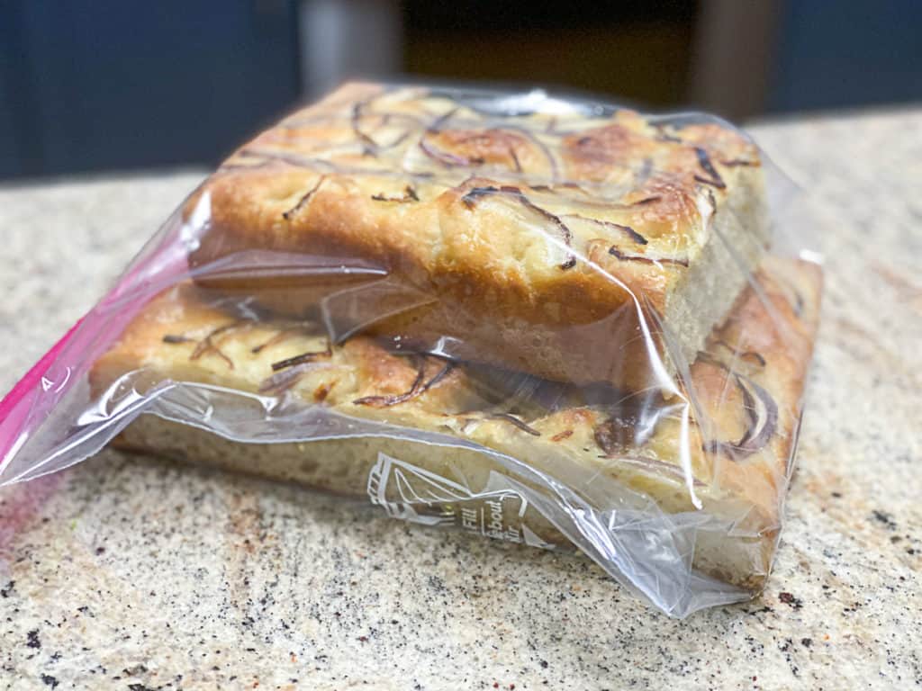 Side shot of storing loafs of bread in a freezer bag.