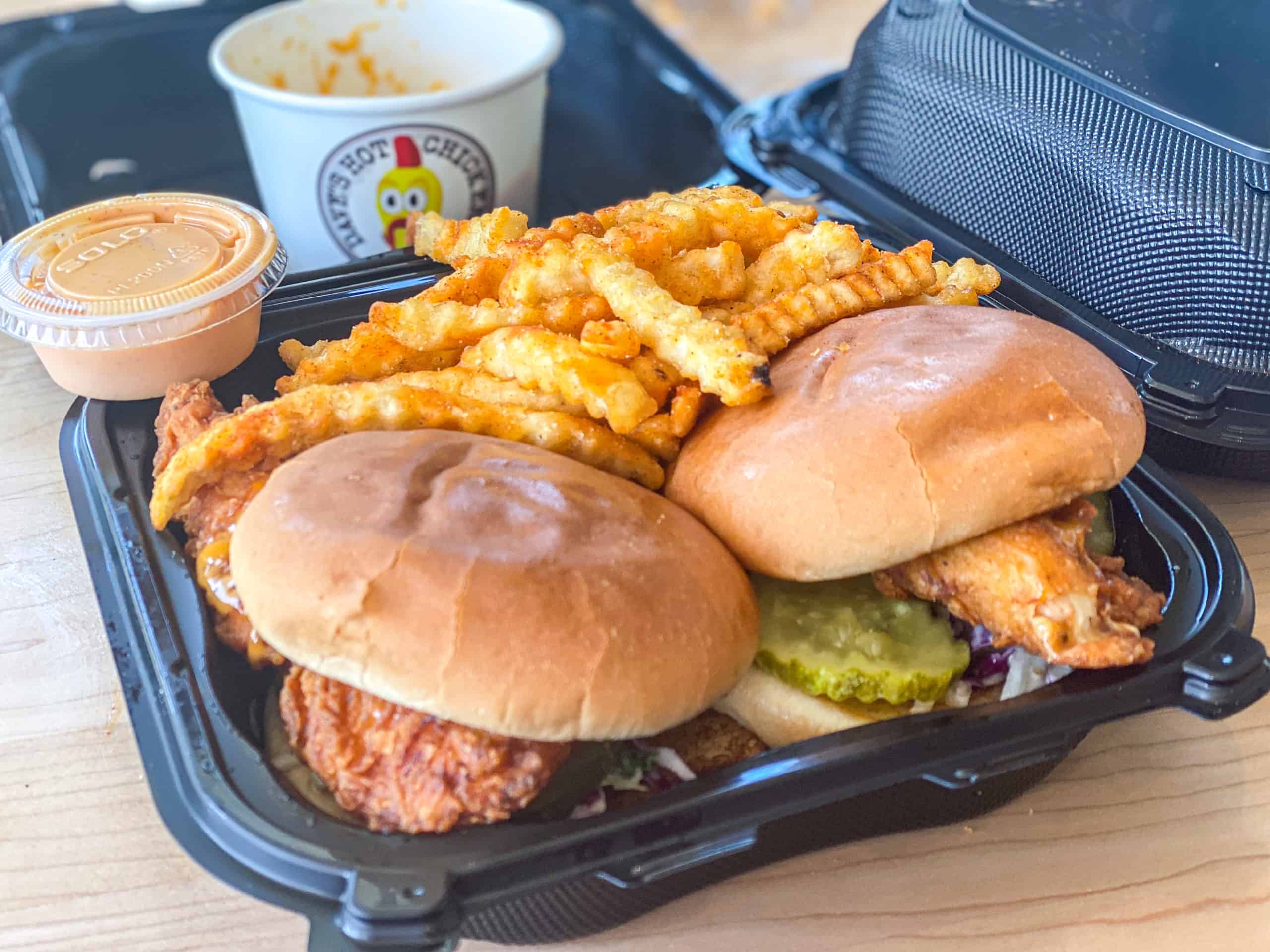 Side shot of hot fried chicken from Dave's with sauce and side mac and cheese and kale slaw.