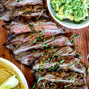 Top down shot of Grilled Skirt Steak Recipe With Marinade and chives and guacamole and tacos.
