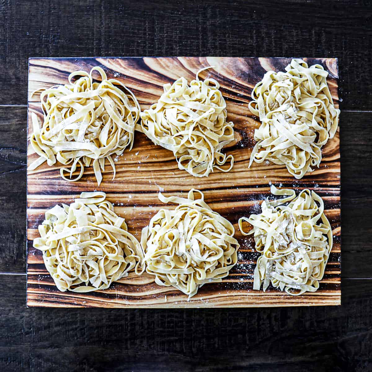 https://sipbitego.com/wp-content/uploads/2021/05/Homemade-Pasta-Recipe-Fettuccine-Linguine-Spaghetti-Sip-Bite-Go-cut-pasta-noodle-nests-on-a-cutting-board.jpg