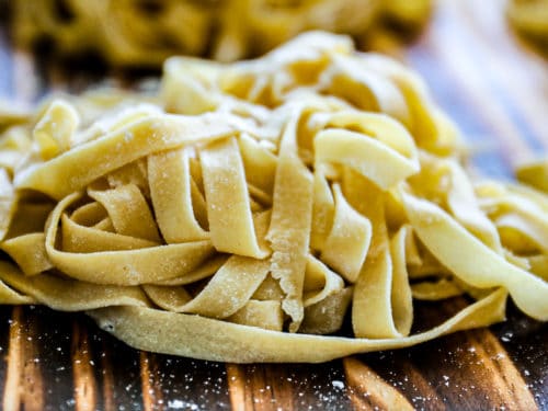 https://sipbitego.com/wp-content/uploads/2021/05/Homemade-Pasta-Recipe-Fettuccine-Linguine-Spaghetti-Sip-Bite-Go-fresh-pasta-noodles-on-a-cutting-board-feature-500x375.jpg
