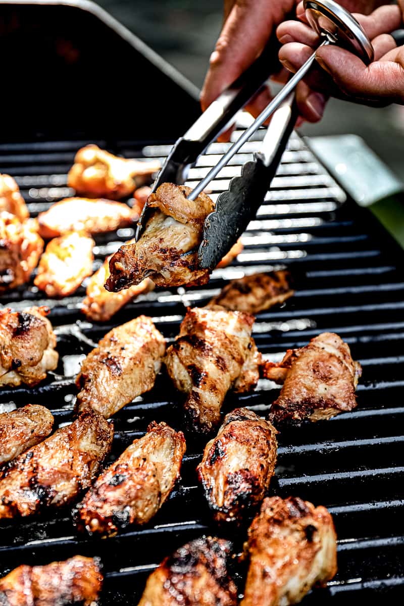 Meat thermometer reading grilled wings temperature.