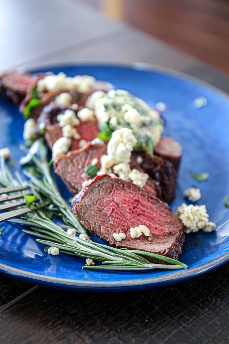 Side shot of Air Fryer Filet Mignon Recipe with rosemary.