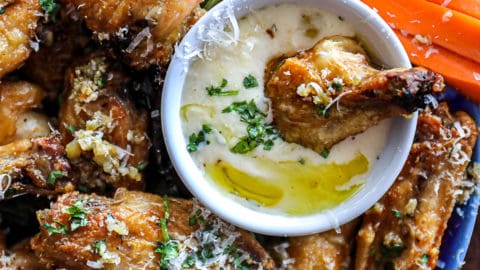 Closeup of Garlic Parmesan Chicken Wings in Alfredo sauce.