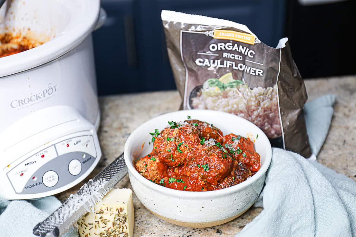 Side shot of Slow Cooked Beef Meatballs With bag of Cauliflower Rice from Trader Joe's.