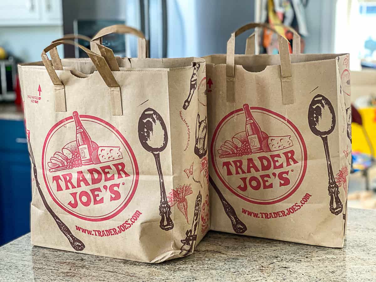 Side shot of two Trader Joe's Haul Shopping Bags On Counter in kitchen.