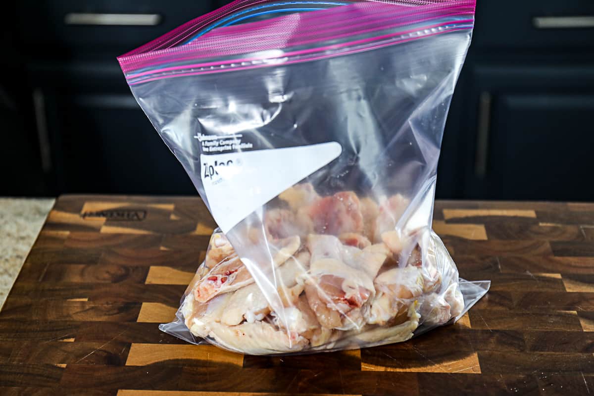 Dry rub seasoned chicken wings in a bag