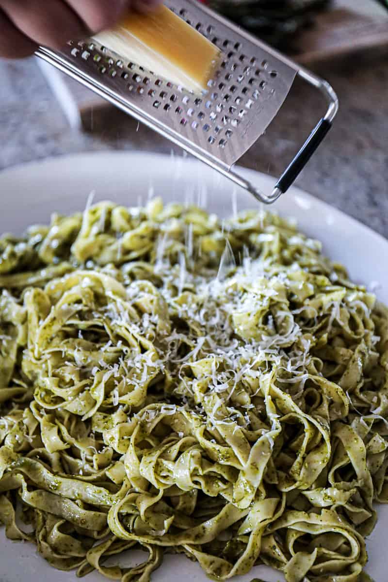 Fresh Fettuccine Pesto Pasta Recipe with grated parmesan cheese.