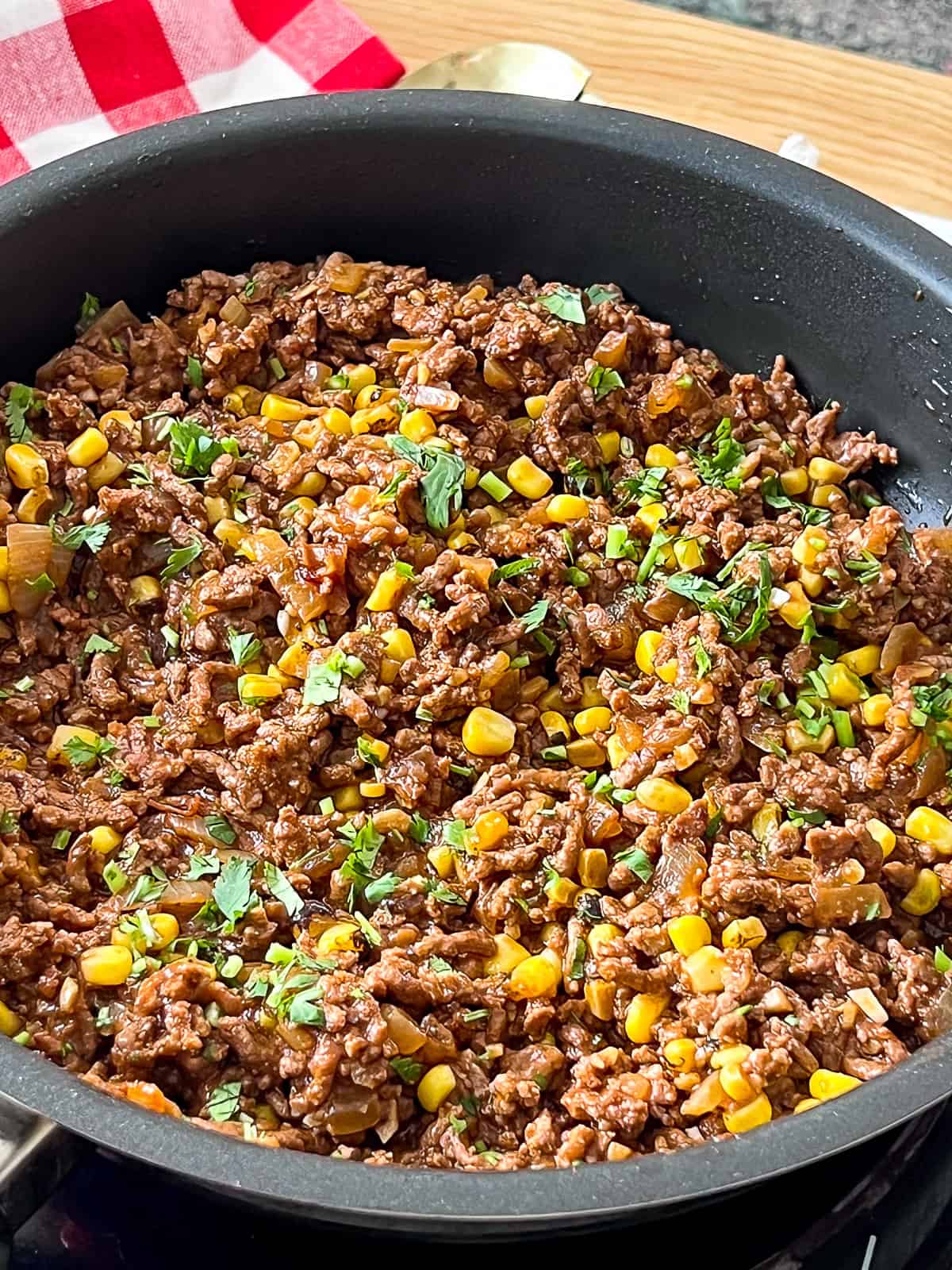 Ground Beef and Corn Taco Skillet Skillet filled with seasoned ground beef corn and taco toppings ready to serve