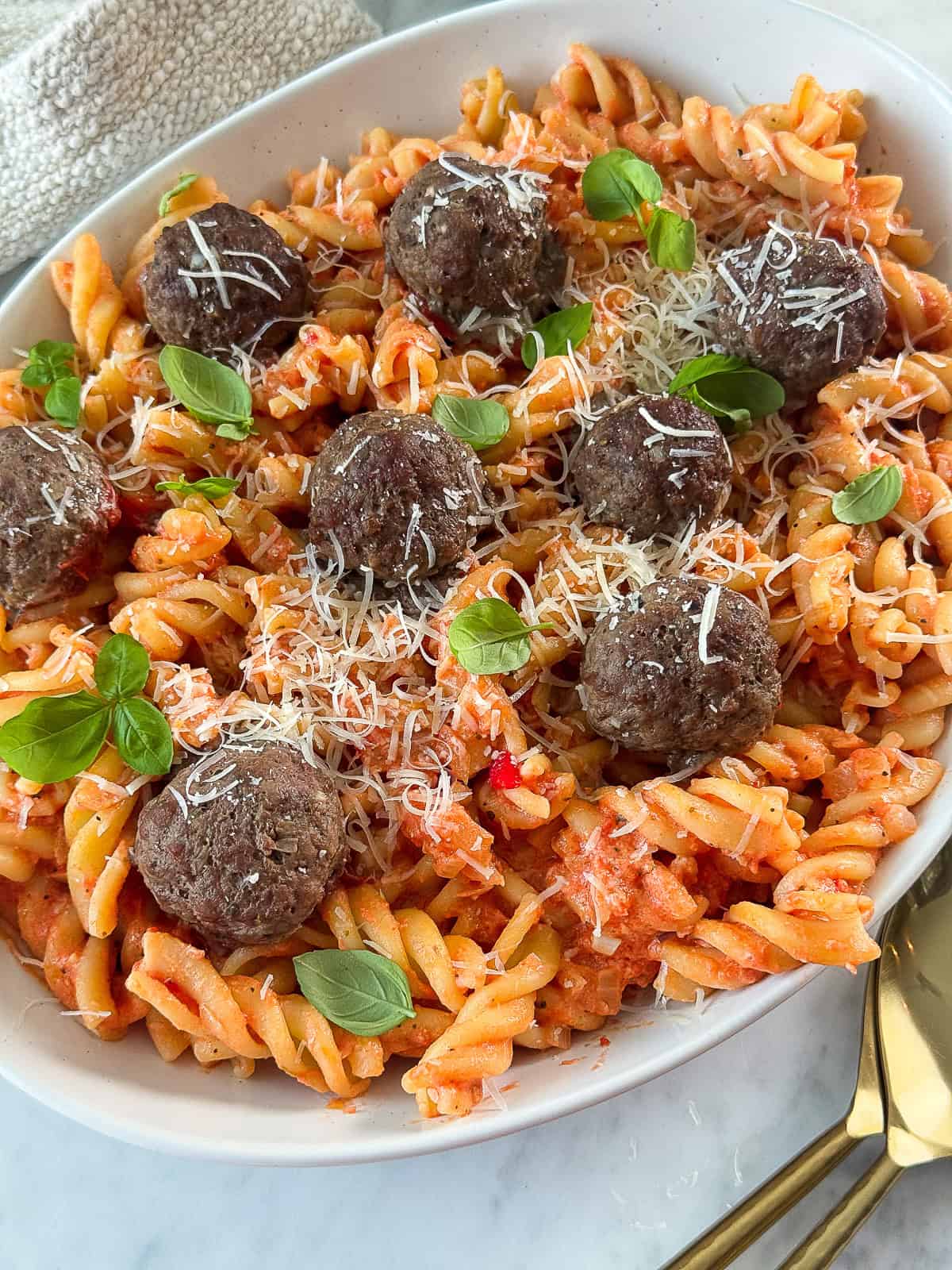 Pink Sauce with Meatballs Creamy pink pasta sauce with juicy meatballs served on a plate garnished with fresh herbs