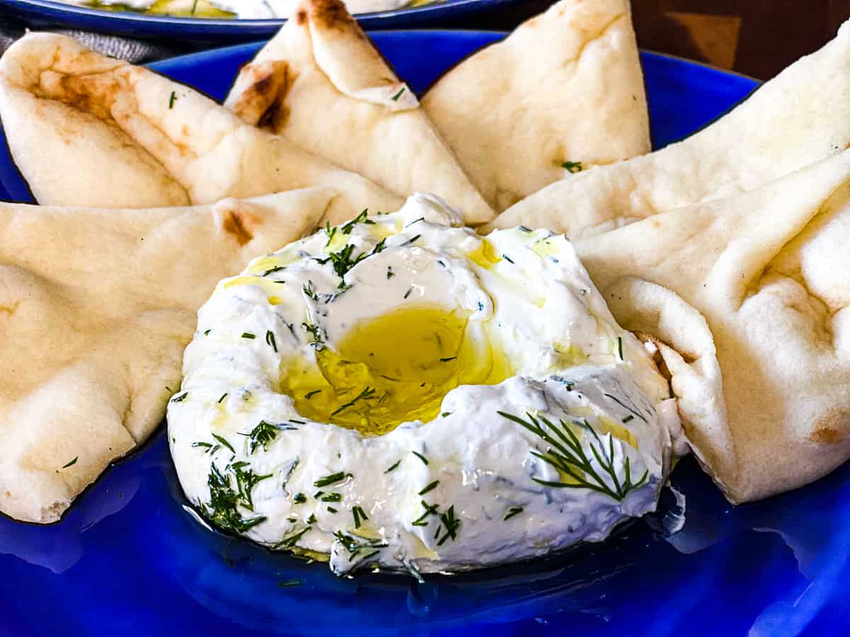 Appetizer Dish with Labneh and dill and pita bread.