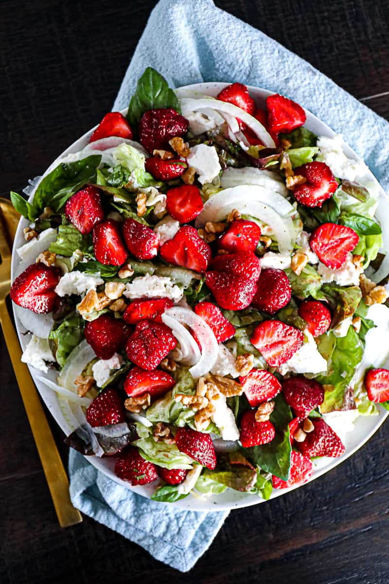 Cold summer salad with strawberries and onions.