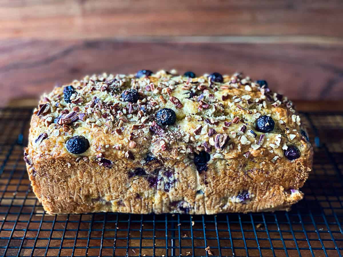 Blueberry Banana Bread With Toasted Nuts cooling on a wire rack.