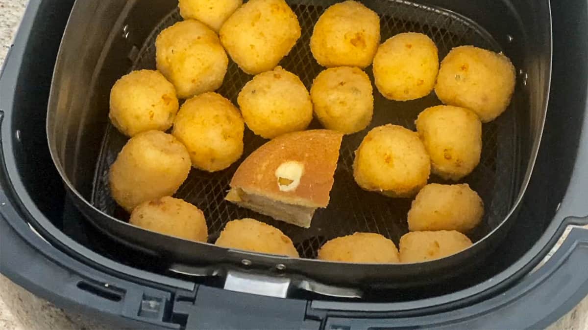 basket of air fryer smoking from lightweight food