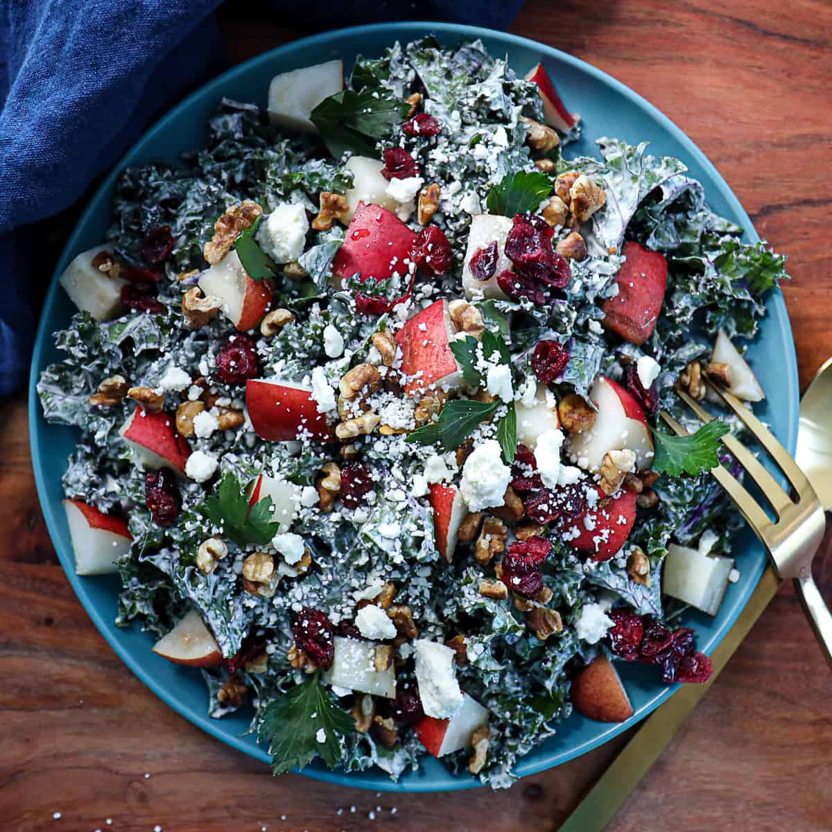 Kale Pear Salad with Tahini Dressing Cranberries and Cheese Crumbles on a serving platter