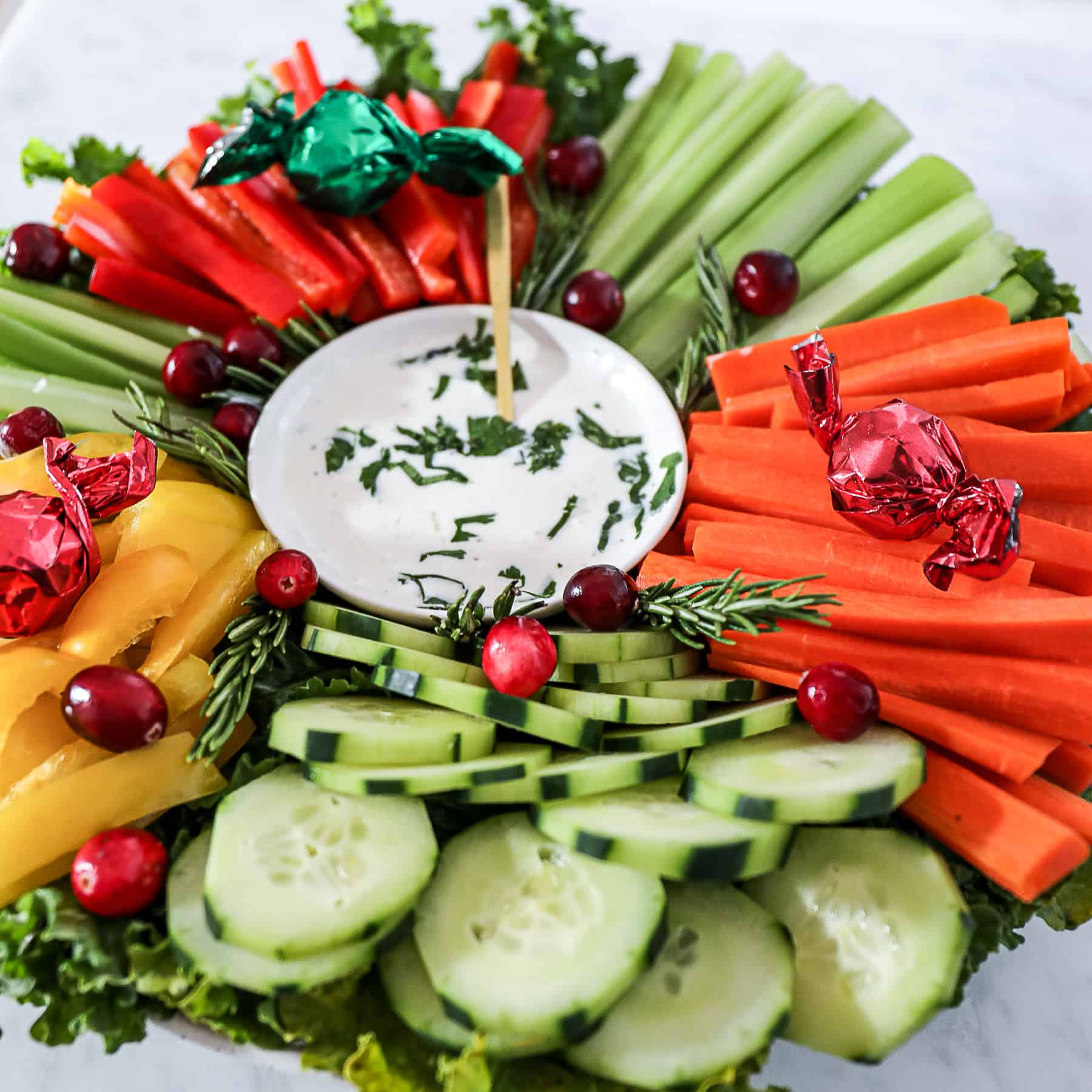 Demonstrating dip in center of vegetable tray for Christmas themed party.