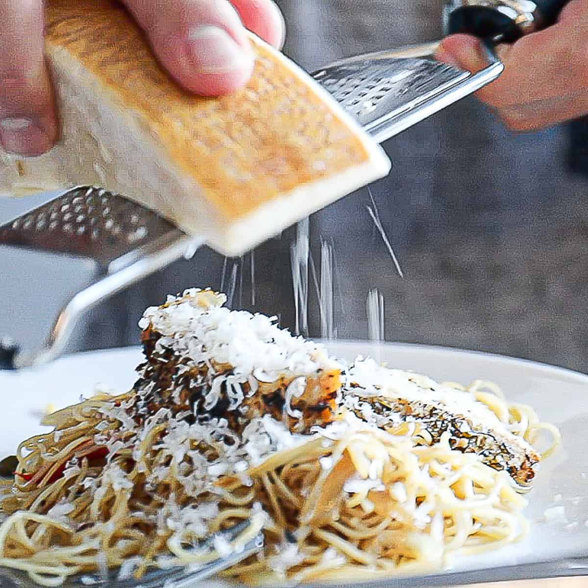 Pasta dinner with chicken and fresh parmesan cheese on a platter