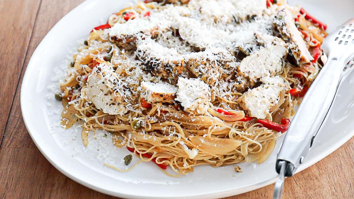 Grating fresh parmesan on pasta