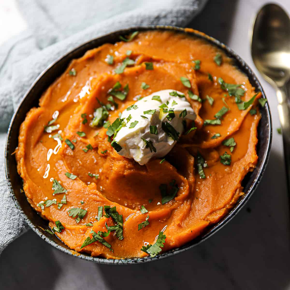 Side dish of pureed Crock Pot Sweet Potatoes Mashed with an immersion blender