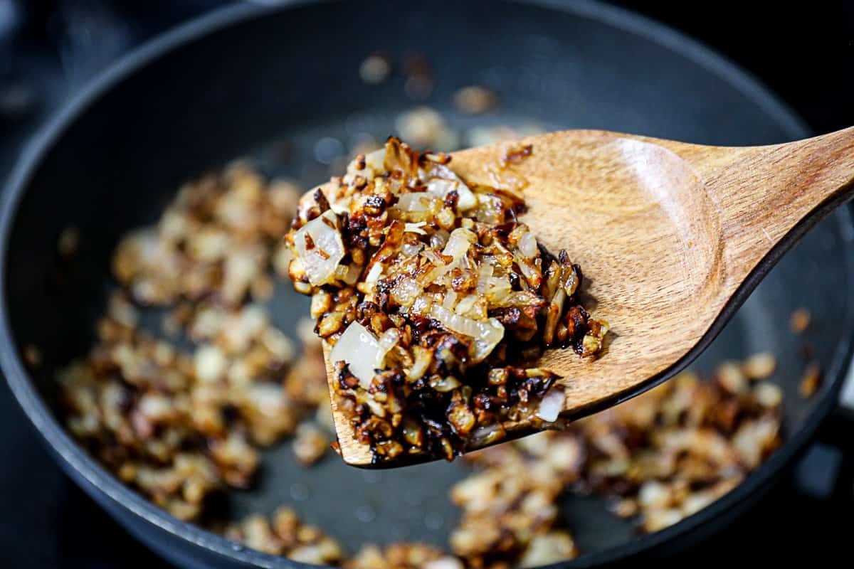 Spoonful of golden brown caramelized shallots