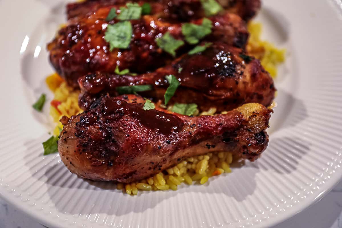 Dinner with Slow Cooked BBQ Chicken Drumsticks with rice on a plate