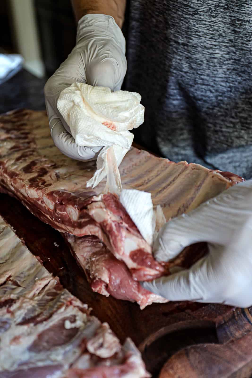 Demonstrating how to remove the membrane from St Louis ribs before smoking
